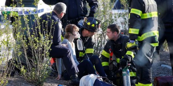 A woman is aided by first responders after sustaining injury on a bike path in lower Manhattan in New York